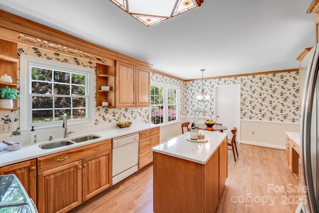 kitchen featuring open shelves, ornamental molding, white dishwasher, wallpapered walls, and a sink