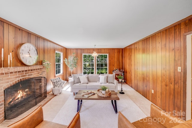 carpeted living area with wood walls, a brick fireplace, and ornamental molding