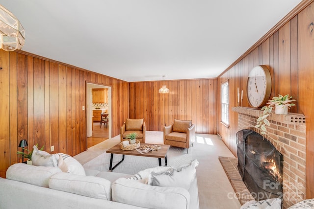 living area with a brick fireplace, wooden walls, and light colored carpet