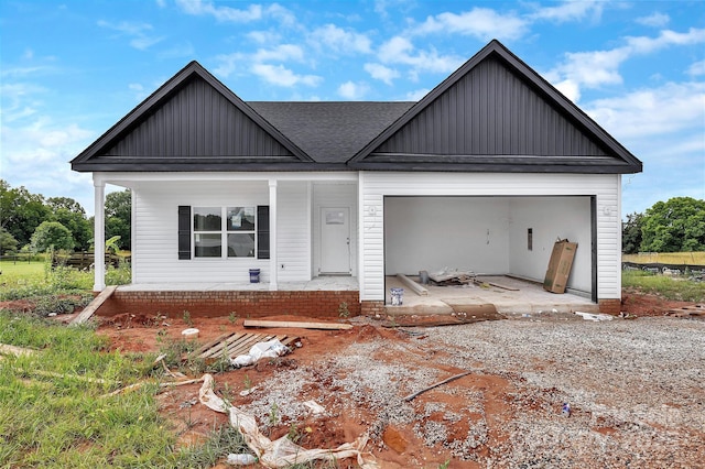 8455 W NC-152 Hwy, Mooresville, NC 28115 - view of front of home featuring board and batten siding, covered porch, an attached garage, roof with shingles, and driveway