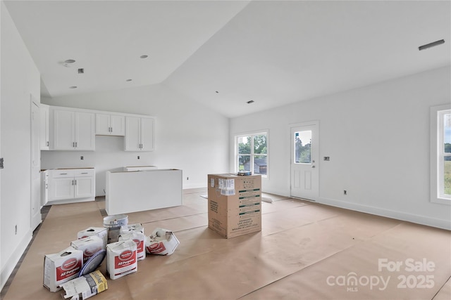 8455 W NC-152 Hwy, Mooresville, NC 28115 - kitchen featuring vaulted ceiling, white cabinets, and a kitchen island