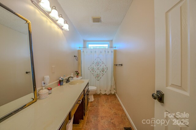 bathroom with visible vents, toilet, a textured ceiling, a shower with shower curtain, and vanity