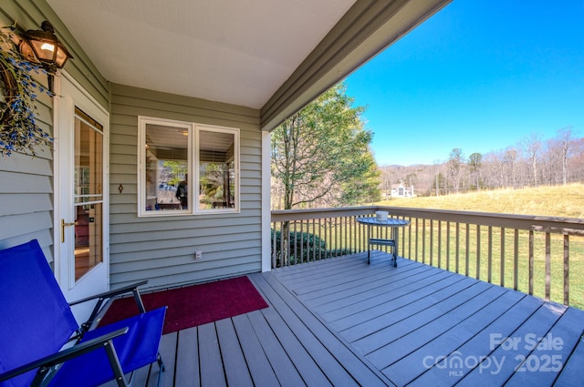 wooden deck with a yard