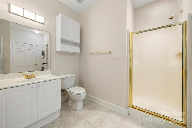 full bathroom featuring a shower stall, tile patterned flooring, baseboards, and stacked washer and clothes dryer
