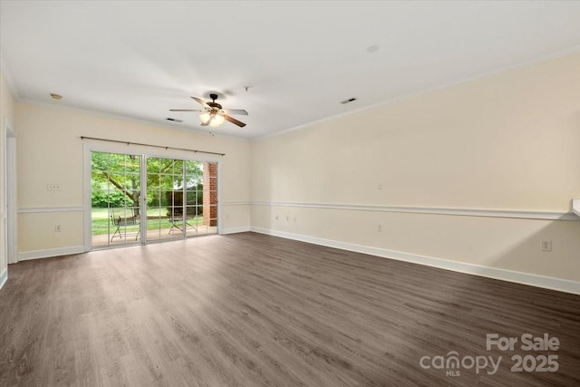 spare room featuring wood finished floors, baseboards, a ceiling fan, and ornamental molding