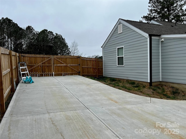 view of patio / terrace featuring fence and a gate