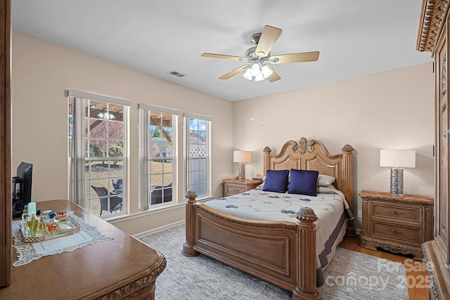 bedroom with ceiling fan, baseboards, and visible vents