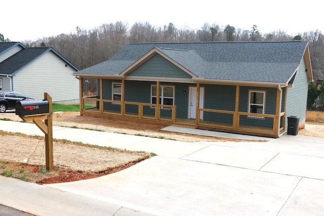 view of front of home featuring covered porch and roof with shingles