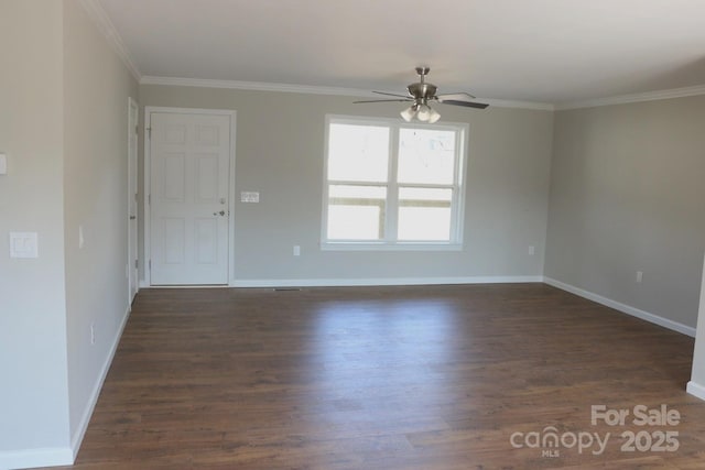 spare room featuring dark wood finished floors, ceiling fan, and ornamental molding