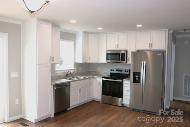 kitchen with a sink, light countertops, white cabinets, and stainless steel appliances