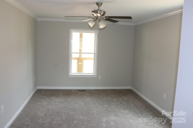 carpeted empty room with crown molding, baseboards, and ceiling fan