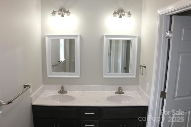 bathroom with a sink and double vanity