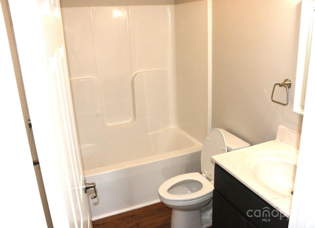 full bathroom with shower / bathtub combination, toilet, vanity, and wood finished floors