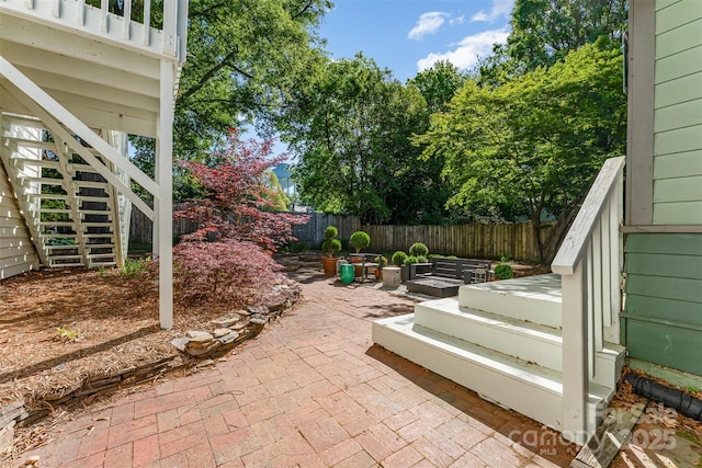 view of patio / terrace with a fenced backyard and stairway