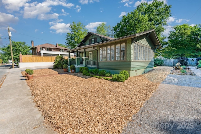 view of front of house featuring fence, a porch, and crawl space