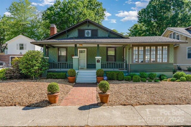 36 Yorktown St NW, Concord, NC 28025 - view of front facade with covered porch, a chimney, and a shingled roof