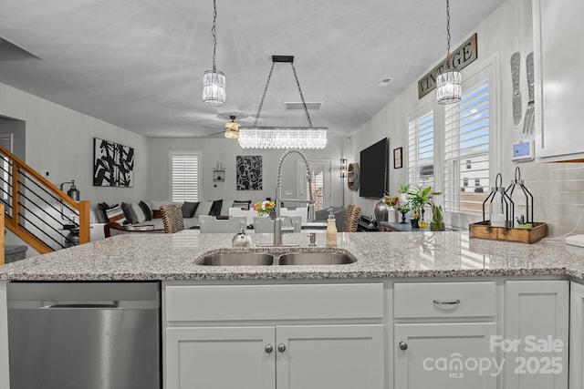 7172 Indigo Way, Denver, NC 28037 - kitchen with stainless steel dishwasher, a sink, a ceiling fan, and white cabinetry