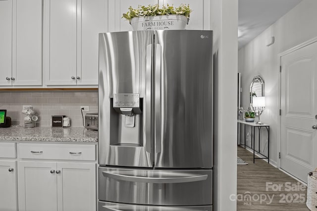 7172 Indigo Way, Denver, NC 28037 - kitchen featuring stainless steel fridge, decorative backsplash, white cabinets, and wood finished floors