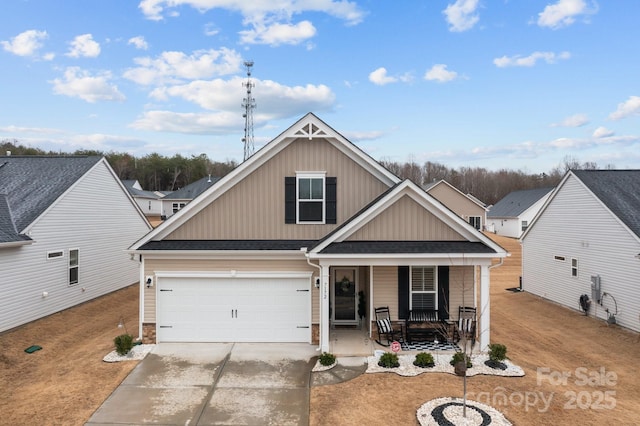 7172 Indigo Way, Denver, NC 28037 - view of front facade featuring a porch, concrete driveway, board and batten siding, and a shingled roof