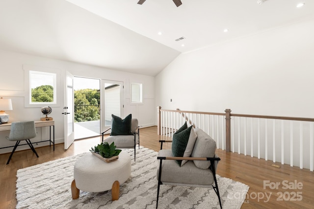 living area featuring a ceiling fan, lofted ceiling, recessed lighting, and wood finished floors