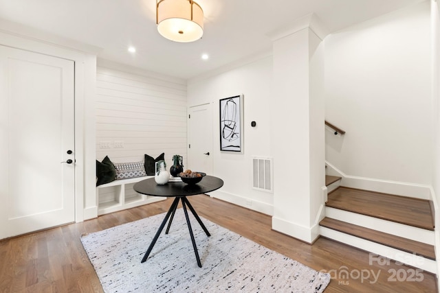 entrance foyer with visible vents, wood finished floors, recessed lighting, stairway, and baseboards