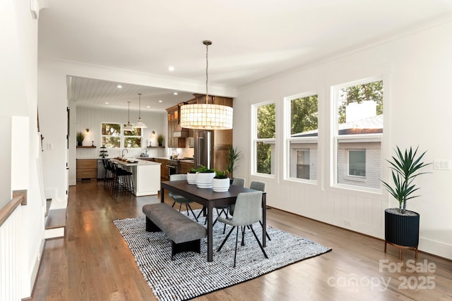 dining room featuring dark wood-style floors, recessed lighting, and an inviting chandelier