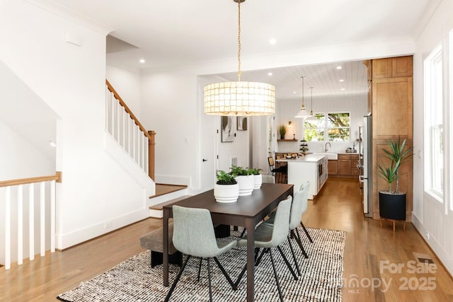 dining area featuring visible vents, baseboards, stairs, light wood-type flooring, and recessed lighting