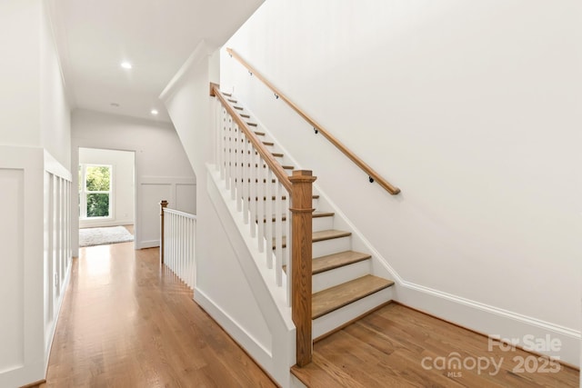 stairs featuring recessed lighting and wood finished floors