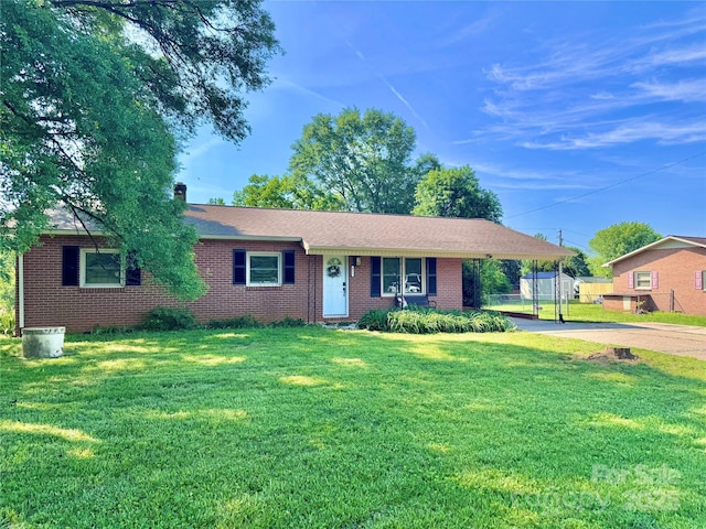 817 Dudley Shoals Rd, Granite Falls, NC 28630 - single story home featuring an attached carport, driveway, brick siding, and a front yard