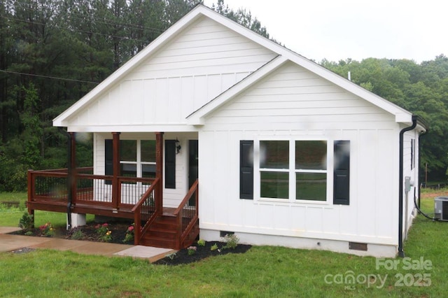 modern farmhouse with a front lawn, central air condition unit, board and batten siding, and crawl space