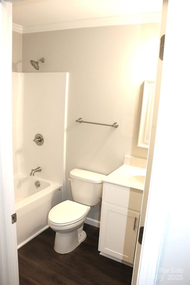 full bath with vanity, wood finished floors, crown molding, shower / tub combination, and toilet