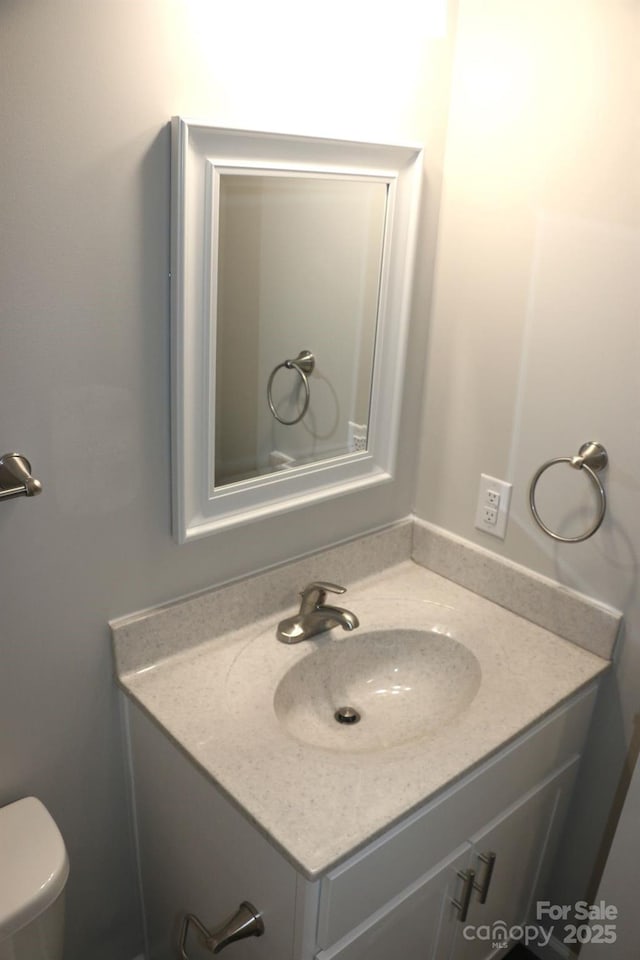 bathroom featuring toilet and vanity