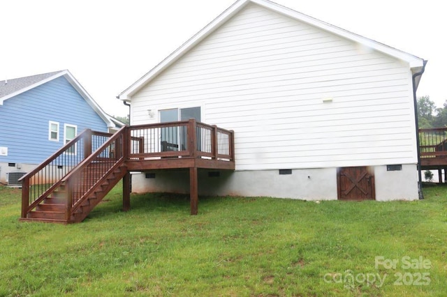 back of property with a wooden deck, central air condition unit, a lawn, and crawl space