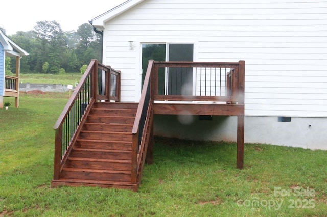 deck with stairs and a yard