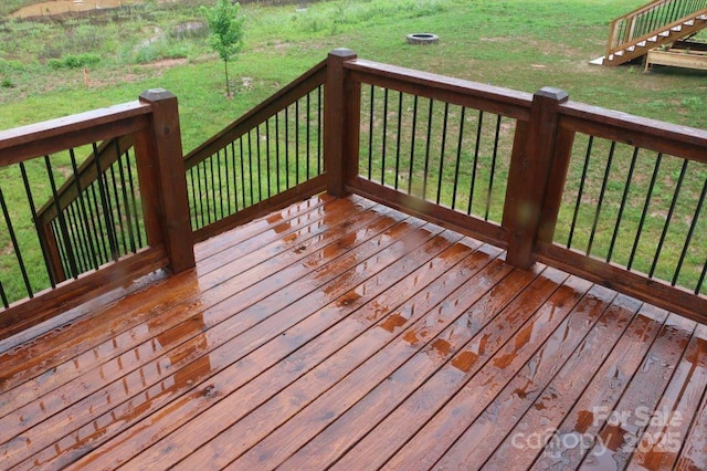 wooden deck featuring a yard