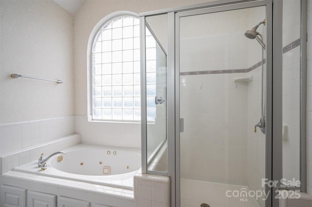 full bath featuring a stall shower and a whirlpool tub