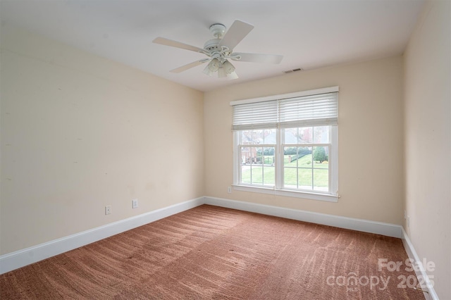 unfurnished room featuring carpet flooring, visible vents, baseboards, and ceiling fan