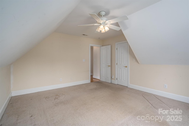 bonus room featuring baseboards, carpet floors, ceiling fan, and vaulted ceiling