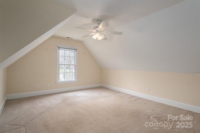 additional living space with baseboards, carpet floors, lofted ceiling, and ceiling fan