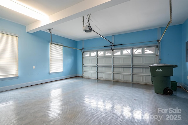 garage with a garage door opener and baseboards