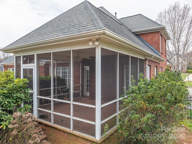 view of home's exterior featuring brick siding and a shingled roof