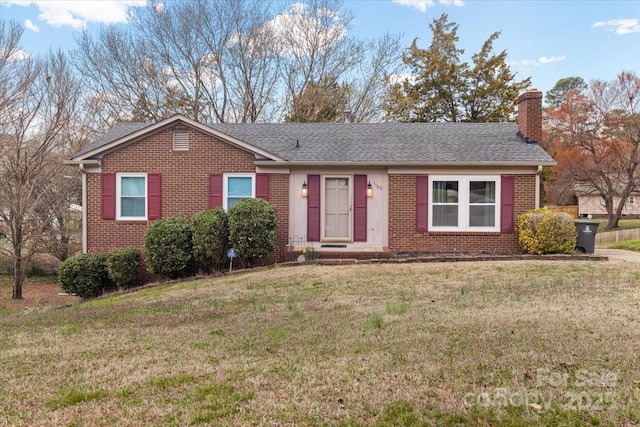 single story home featuring a front lawn, brick siding, roof with shingles, and a chimney