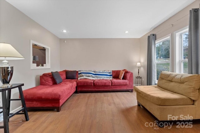 living area with recessed lighting and light wood finished floors