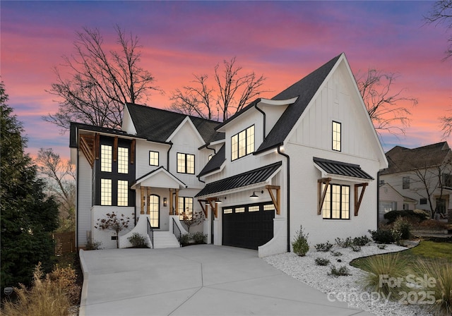 680 Ideal Way, Charlotte, NC 28203 - modern farmhouse style home featuring brick siding, metal roof, driveway, an attached garage, and a standing seam roof
