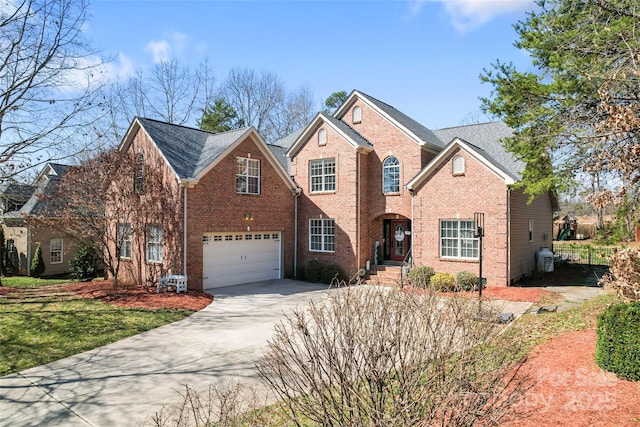 traditional-style house featuring brick siding, concrete driveway, and an attached garage