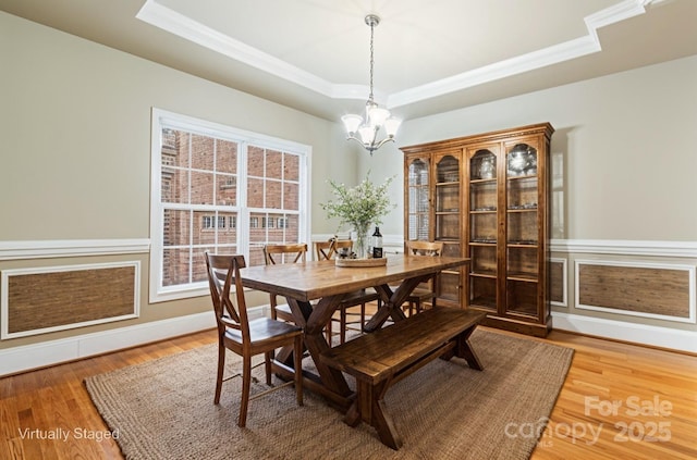 4858 Sagittarius Cir, Denver, NC 28037 - dining area with a raised ceiling, crown molding, a chandelier, and light wood-style floors
