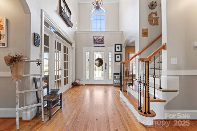 4858 Sagittarius Cir, Denver, NC 28037 - entryway with arched walkways, stairs, wood finished floors, a towering ceiling, and french doors