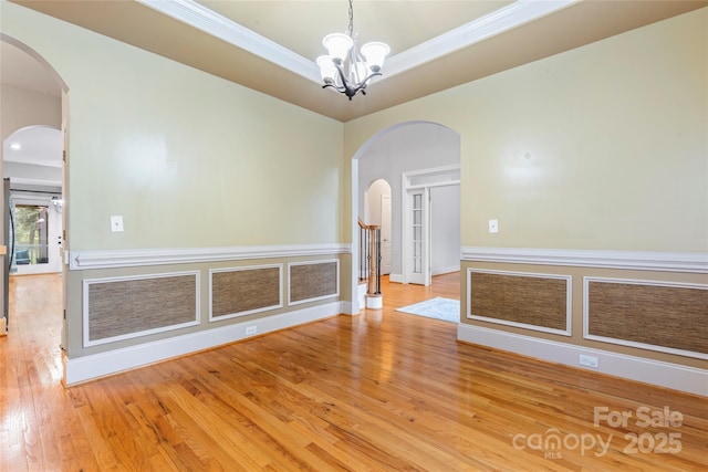 4858 Sagittarius Cir, Denver, NC 28037 - spare room with wood finished floors, a chandelier, arched walkways, baseboards, and crown molding