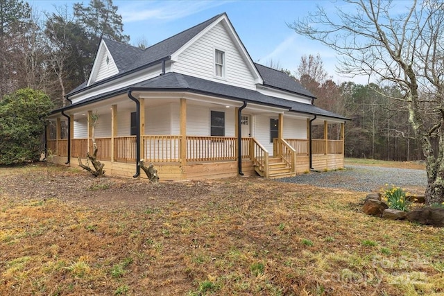 farmhouse-style home featuring a porch and a shingled roof