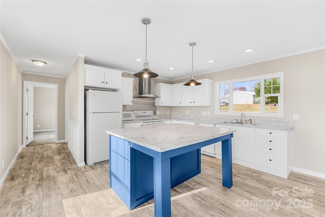 kitchen featuring a kitchen island, crown molding, light countertops, white appliances, and wall chimney exhaust hood